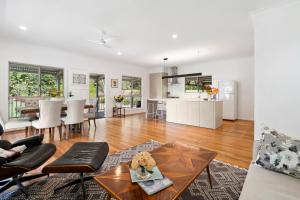 a living room with a table and a kitchen at Montville Retreat offgrid luxury in Montville