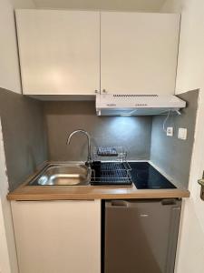 a small kitchen with a sink and a sink at Charme Provençal à Manosque - Centre Historique in Manosque