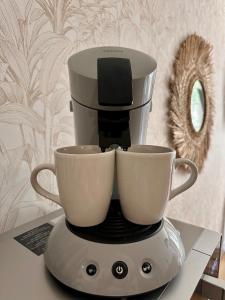 a coffee maker with two cups on top of it at Charme Provençal à Manosque - Centre Historique in Manosque