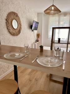 a dining room table with a plate on top of it at Charme Provençal à Manosque - Centre Historique in Manosque