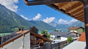 a view from a house with a view of a river and mountains at Ferienwohnung Bergzauber in Maurach