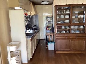 a kitchen with wooden cabinets and a sink and a counter at Lemonso - Vacation STAY 19106 in Ichihara