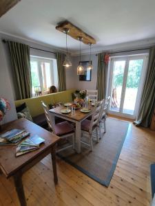 Un comedor y una sala de estar con mesa y sillas. en Natur und Wellness ''auf der Hardt'' -Jacuzzi- Sauna- Kinderausstattung- Alleinlage im Wald, en Mürlenbach 44 fotos más