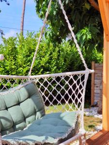 a swing with a chair in a yard at La Maison Bisca in Biscarrosse-Plage