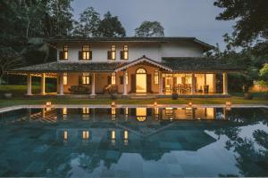 a house with a pool in front of it at Kalukanda House in Weligama