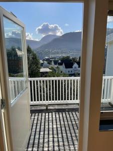 an open door to a balcony with mountains in the background at HB HolidayHomes - The White Pearl in Tromsø