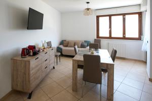 a living room with a table and a couch at Nuvole&Lenzuola in Pescara