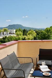 two chairs and a table on a balcony with a view at Francesca Apartmanlakása in Tapolca