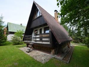 a small house with a gambrel roof on a yard at Holiday Home near Klínovec Ski Lift in Loučná pod Klínovcem