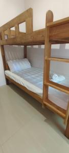 two bunk beds in a room with a blue bed at Z and j Transient House in Lapasan