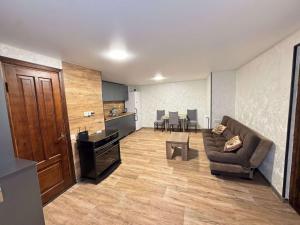 a living room with a couch and a table at House Lia Apartment Likani in Borjomi