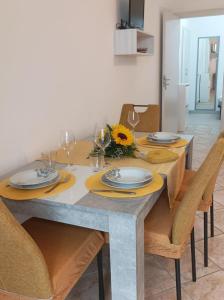 a dining room table with yellow napkins and chairs at Casa Vacanze Nausicaa in Tiriolo +3 photos