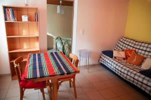 a living room with a couch and a table at La Cantine Logement au calme proche bord de Loire in Decize +1 photo