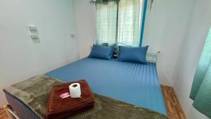 a blue bed with a roll of toilet paper on it at Phangan long island Bar in Ko Phangan