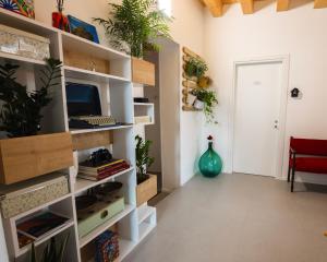 a living room with a wall of shelves with plants at Panormos91 Rooms&Terrace in Palermo