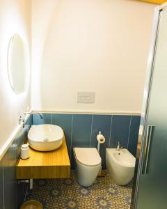 a bathroom with a toilet and a sink at Panormos91 Rooms&Terrace in Palermo