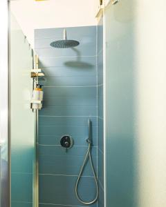 a bathroom with a shower with blue tiles at Panormos91 Rooms&Terrace in Palermo +12 photos