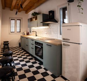 a kitchen with a refrigerator and a checkered floor at Panormos91 Rooms&Terrace in Palermo