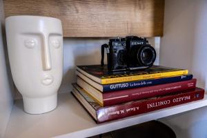 a camera sitting on top of a stack of books at Panormos91 Rooms&Terrace in Palermo