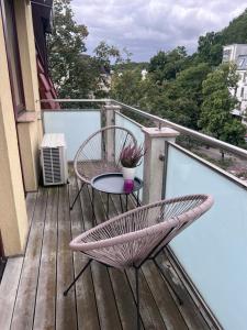 a patio with a table and chairs on a balcony at Apartament z balkonem in Sopot