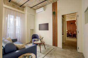 a living room with a blue couch and a table at Rome for Two in Rome