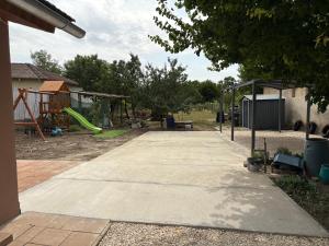 a backyard with a playground with a swing set at Alföldi-kuckó in Makó