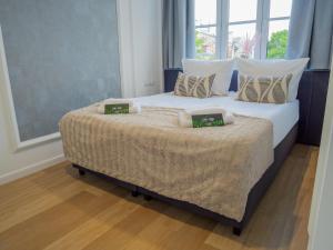 a bedroom with a bed with two pillows on it at Długa 17 Residence in Kraków