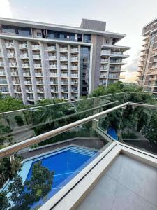 a glass walkway in a city with a building at Seaside serenity tambuli condo in Maribago +4 photos