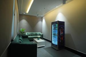 a room with a couch and a video game machine at Hotel Avasa in Tenāli