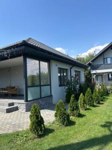 a house with a lawn in front of it at Casa Berbec 3 Studio in Dealul Viei