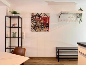 a kitchen with a painting on the wall at Corner Loft - Altstadt Design Apartment in Freiburg im Breisgau