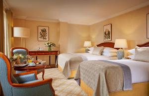 a hotel room with two beds and a table at Killarney Plaza Hotel & Spa in Killarney