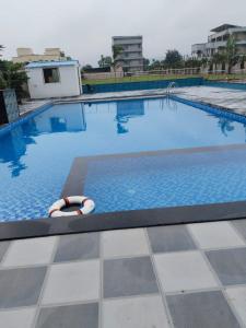 a large swimming pool with a lifebuoy in it at Ranthambhore Grand Mahal in Sawāi Mādhopur