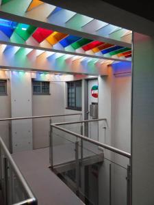 a brightly lit room with a rainbow ceiling at Oh! Oriente Hotel in Mexico City