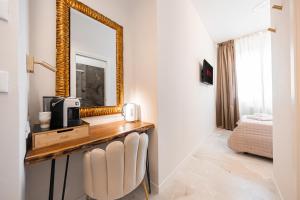 a room with a mirror and a table and chairs at Avenue Suites in Bologna +88 photos