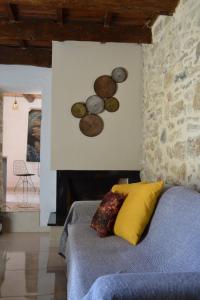 a bedroom with a bed withcoins on the wall at Esion Villas in Áyios Míron +20 photos