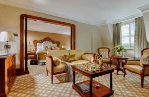 a living room with a bed and a large mirror at Killarney Plaza Hotel & Spa in Killarney +35 photos