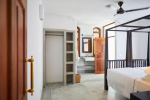 a bedroom with a bed and a bathroom with a sink at Kalukanda House in Weligama +33 photos