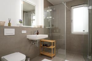 a bathroom with a sink and a shower and a toilet at Wohnkultur - Ferienhaus für 10 mit Terrasse und Garten in Wiesloch +36 photos