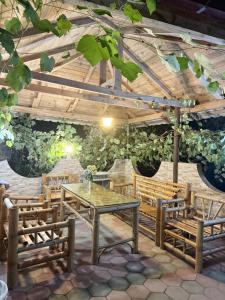 a patio with a table and chairs and a wooden ceiling at Konstantin House in Sarpi