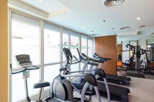 a gym with treadmills and elliptical machines at Movenpick Suriwongse Hotel Chiang Mai in Chiang Mai