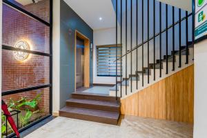 a staircase in a house with a brick wall at Treebo Deluxe Inn, Chromepet in Chennai