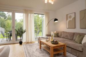 a living room with a couch and a table at Wohnkultur - Ferienhaus für 10 mit Terrasse und Garten in Wiesloch