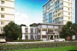 a white car parked in front of a large building at MyOneSpace4u at One Spatial Condo Hotel in Iloilo City