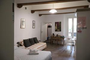 a living room with a couch and a dining room at LOFT CON CORTILE in Forlì