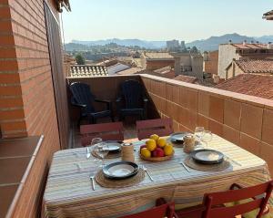 a table with a bowl of fruit on a balcony at LAMAR Valderrobres in Valderrobres