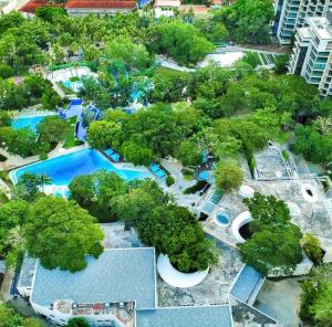 an overhead view of a pool at a resort at Seaside serenity tambuli condo in Maribago