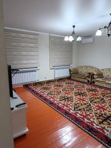 a living room with two couches and a rug at Дача in Vorontsovskoye