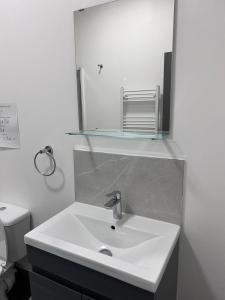 a bathroom with a white sink and a mirror at Triple room Private Bath Near LFC Free Street Parking No Breakfast in Liverpool