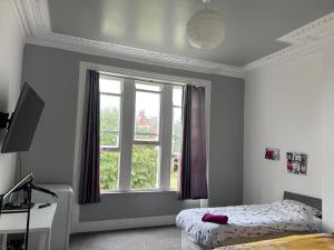 a bedroom with a bed and a window at Triple room Private Bath Near LFC Free Street Parking No Breakfast in Liverpool